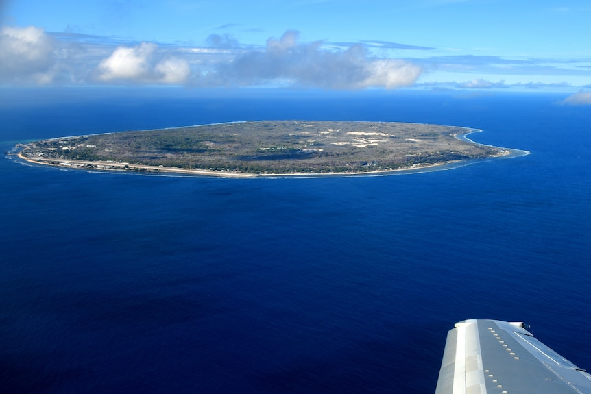 A bird's eyeview of Nauru. A small, circular island sitting in the middle of a deep blue ocean.