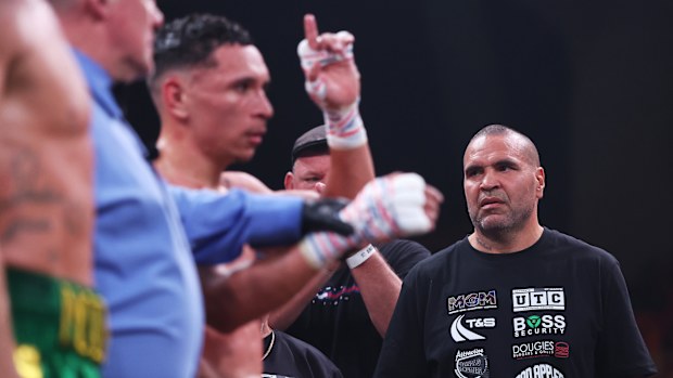 Anthony Mundine looks on as Rahim Mundine defeats Lance McDonald.