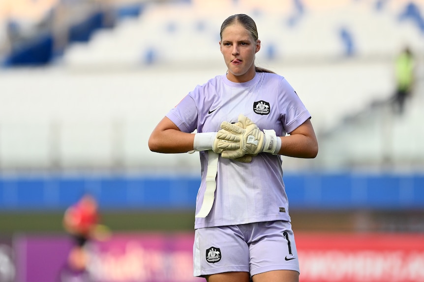 Ilonda Melegh adjusts her gloves and sticks out her tongue