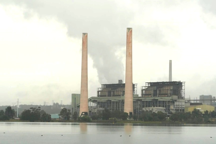 A coal-fired power station as seen from across a waterway.