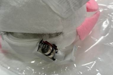 A close up of a battery attached to a backpack