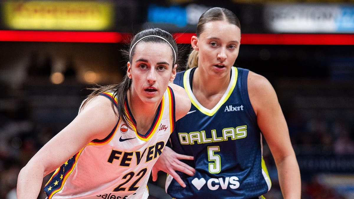 Indiana Fever guard Caitlin Clark and Dallas Wings guard Paige Bueckers during an inbounds play at Gainbridge Fieldhouse