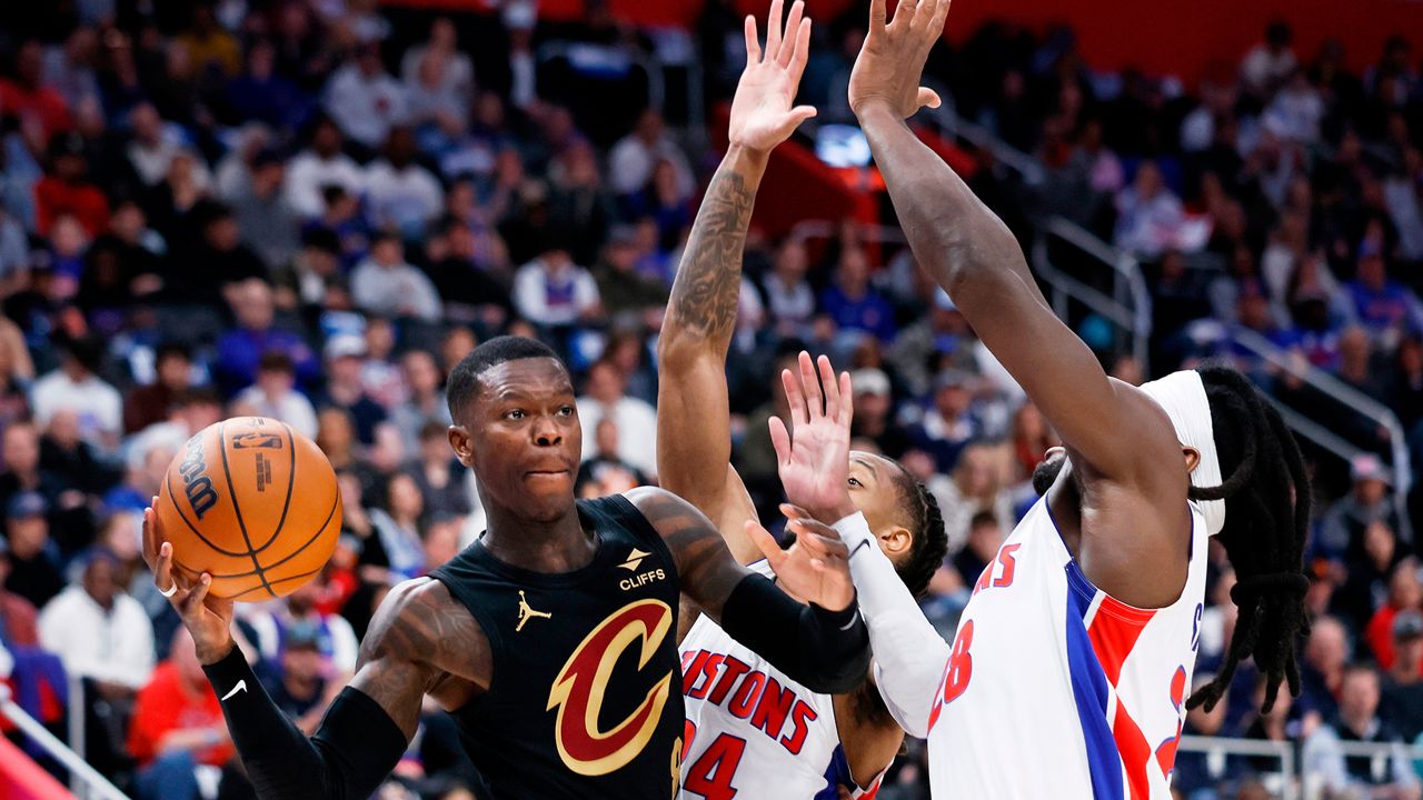 Cleveland Cavaliers guard Dennis Schroder, left, passes the ball against Detroit Pistons guard Daniss Jenkins (24) and forward Isaiah Stewart (28) during the first half in Game 2 of a second-round NBA playoffs basketball series, Thursday, May 7, 2026, in Detroit. (AP Photo/Duane Burleson)