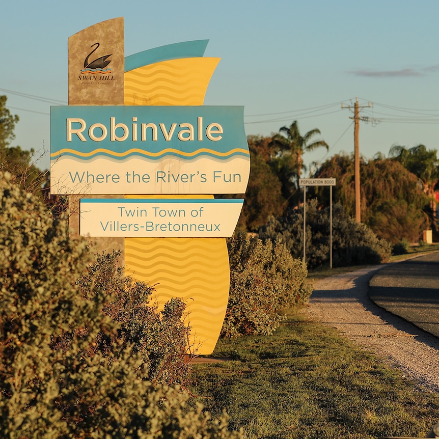 A large roadside sign reads: 'Robinvale Where the River's Fun Twin Town of Villiers-Bretonneux' 