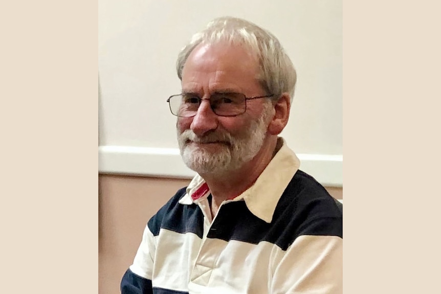 A man with grey hair and glasses