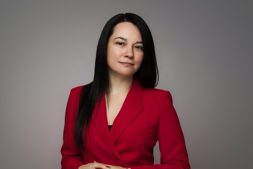 A professional woman in a red suit