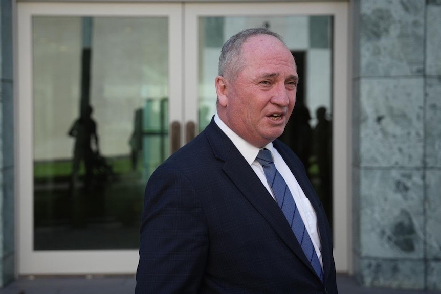 A balding man in a navy suit