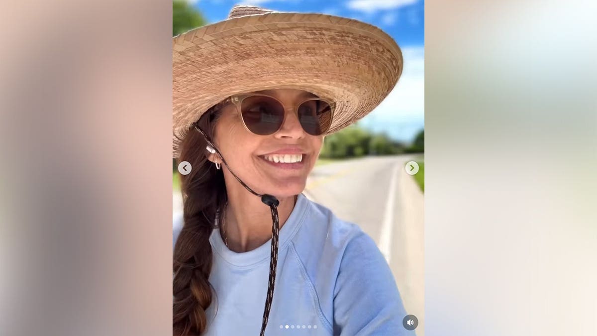 Charisma Carpenter smiling as she walks around her neighborhood.
