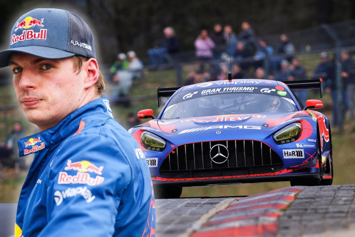 Verstappen in Red Bull kit looking over his Mercedes amg car driving on the Nurburgring