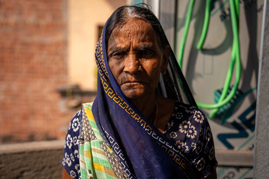 A woman looks at the camera.