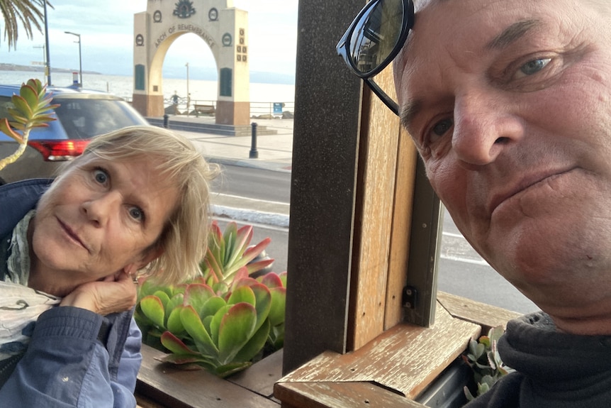 A couple taking a selfie at a restaurant
