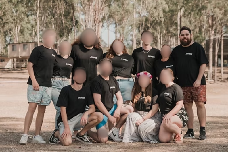 A group of people with their faces blurred except for one man