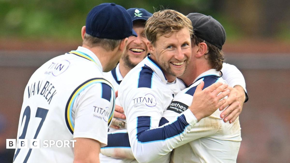 Joe Root is hugged by his team-mates after taking a wicket for Yorkshire against Somerset