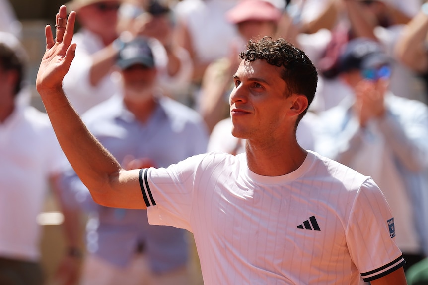 Juan Manuel Cerundolo waves to the French Open crowd.