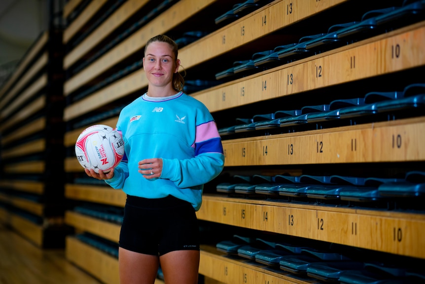 Netballer Jamie-Lee Price holds a netball in hand.