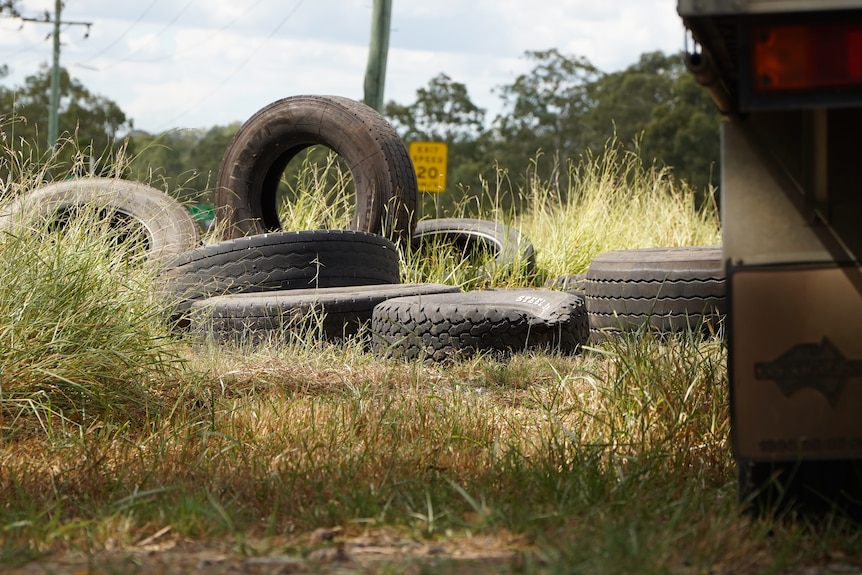 Roughly a dozen busted tires dumped in a patch of bush-land in Ipswich, Queensland.