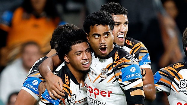 Faaletino Tavana of the Tigers celebrates with teammates after scoring a try.