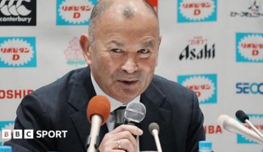 Eddie Jones speaks into a microphone