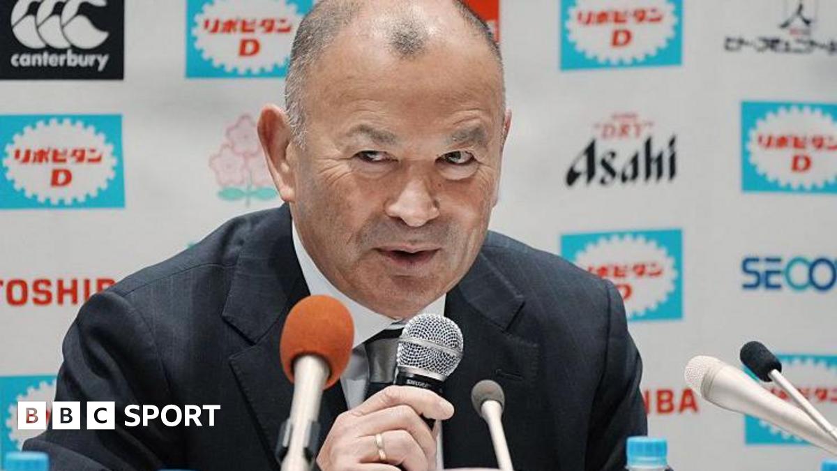 Eddie Jones speaks into a microphone