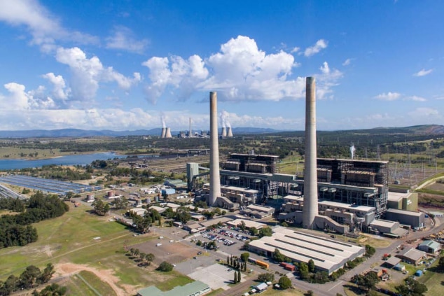 A power station beneath a clear sky.