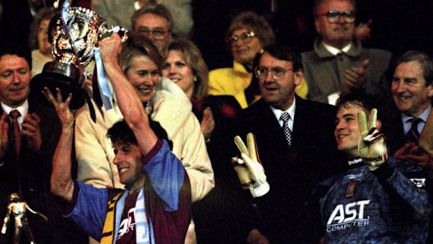 Aston Villa captain Andy Townsend raises the League Cup next to Mark Bosnich in 1996 at Wembley.