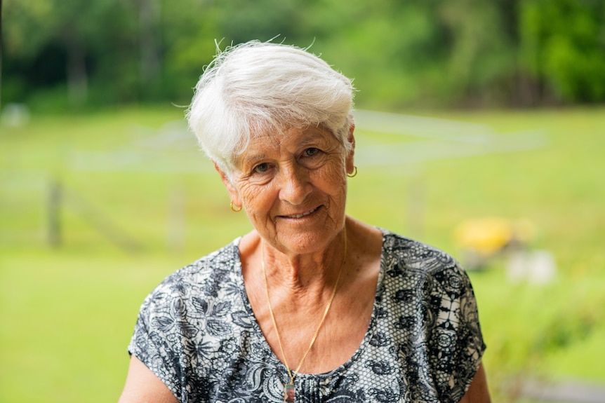 An elderly woman looking at the camera.