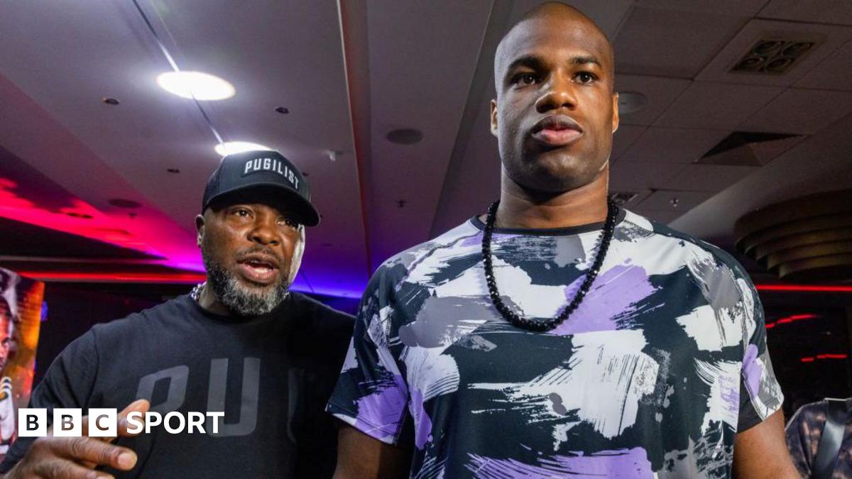 Don Charles (left) wearing a black t-shirt and baseball cap is next to Daniel Dubois (right) who is wearing a patchwork white, black and purple t-shirt