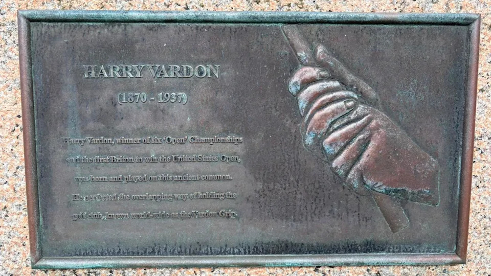 A plaque showing a pair of hands doing the Vardon grip. There is a written description of the technique alongside it.