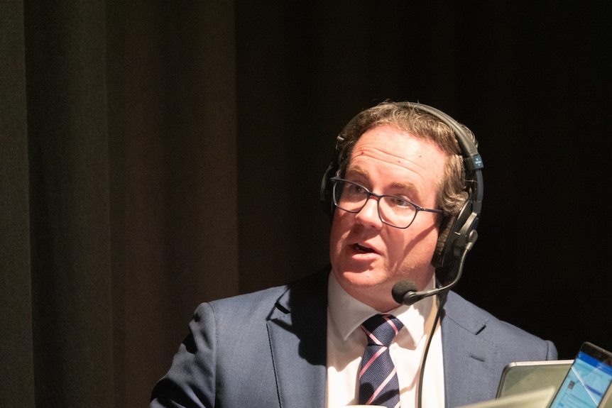 Man in suit wearing radio headset