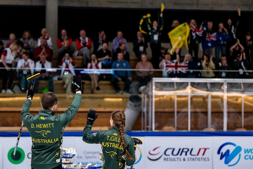 Dean Hewitt and Tahli Gill wave to the crowd of curling fans.