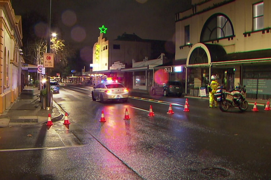 Police at the scene of a Goodwood Road crash at night