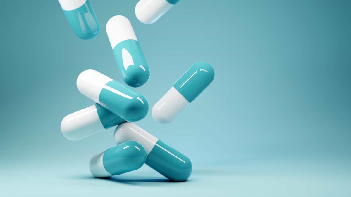 Falling pills in a blue background.
