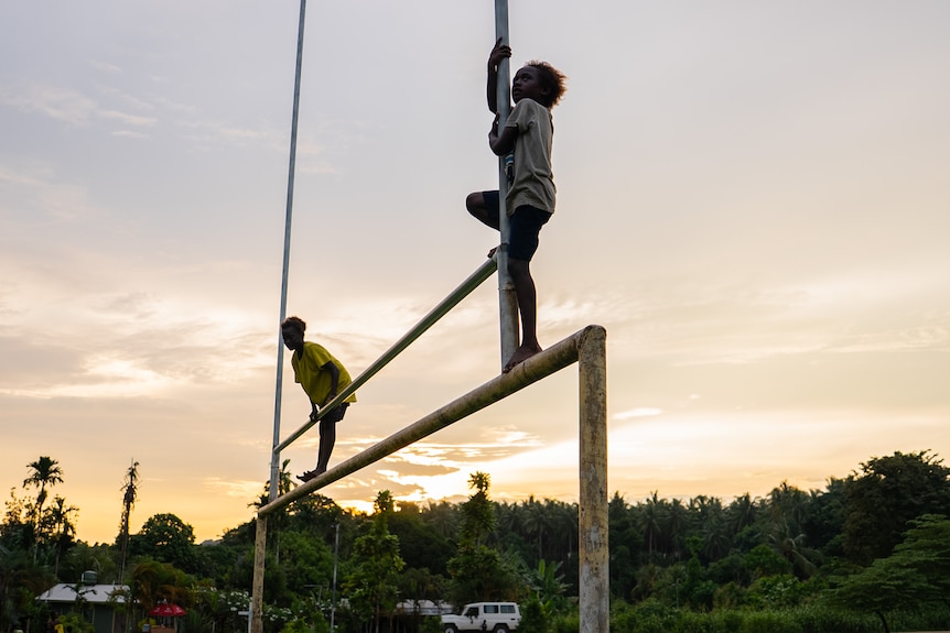 Children take in the view of sunset in Buka, north Bougainville.