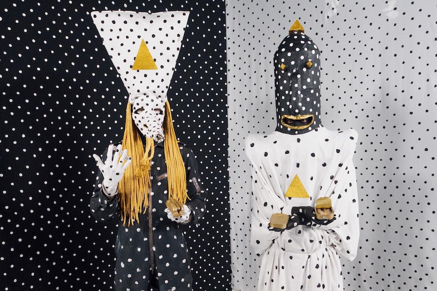 Two people in spotted costumes.