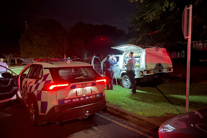 Police cars on the side of the road.