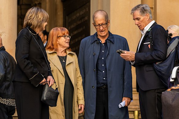 Greig Pickhaver, second right, also known as HG Nelson is seen departing during the memorial for ABC presenter James Valentine.