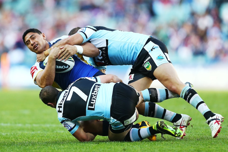 Taumalolo runs the ball during a rugby league match.
