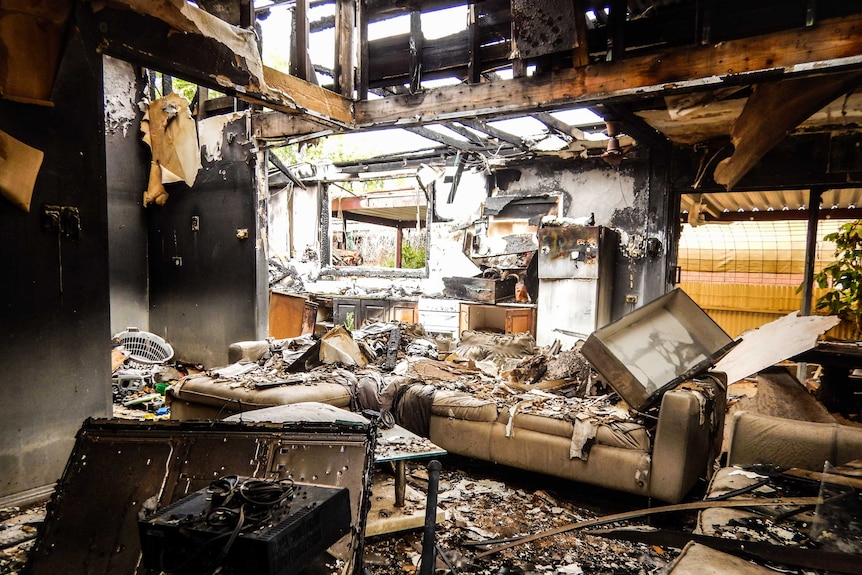 Charred remains of kitchen and lounge room after fire destroyed hostel in Robinvale Victoria