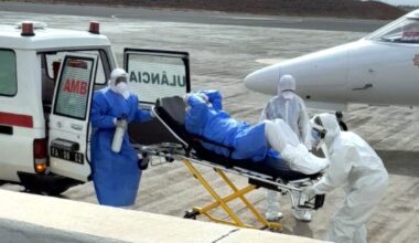 Health workers transfer a hantavirus patient from an ambulance to a medical aircraft