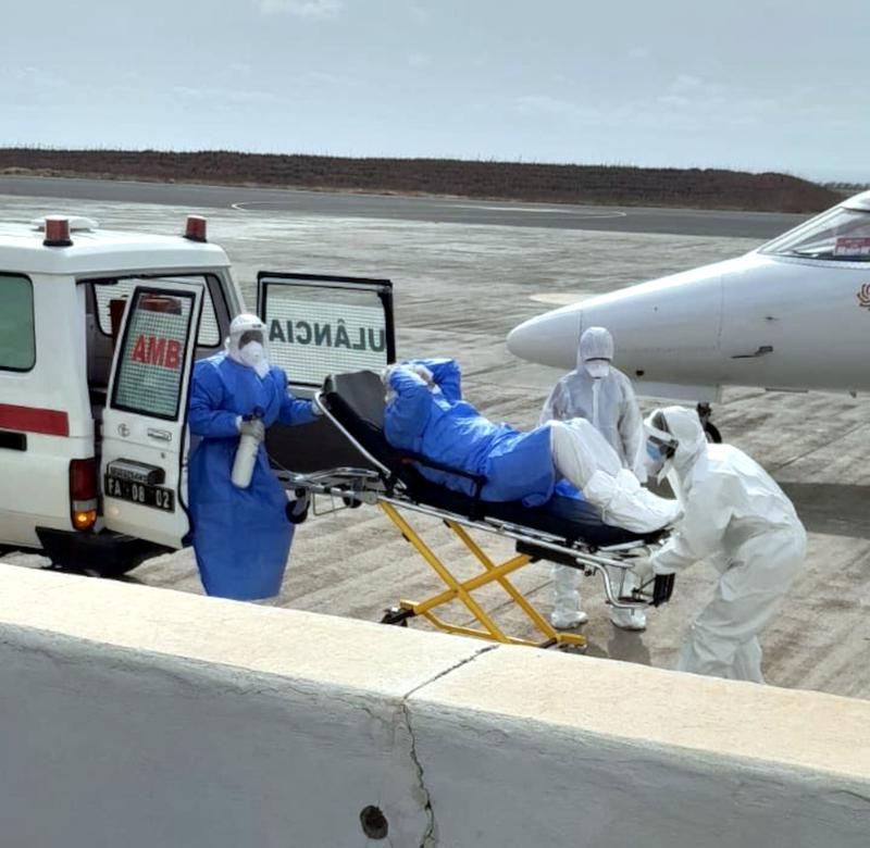 Health workers transfer a hantavirus patient from an ambulance to a medical aircraft