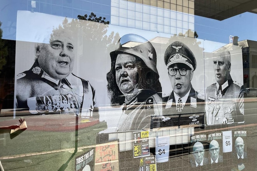 A black and white poster showing four people dressed in Nazi uniforms.