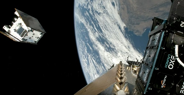 A small satellite on the left and the deploying spacecraft on the right