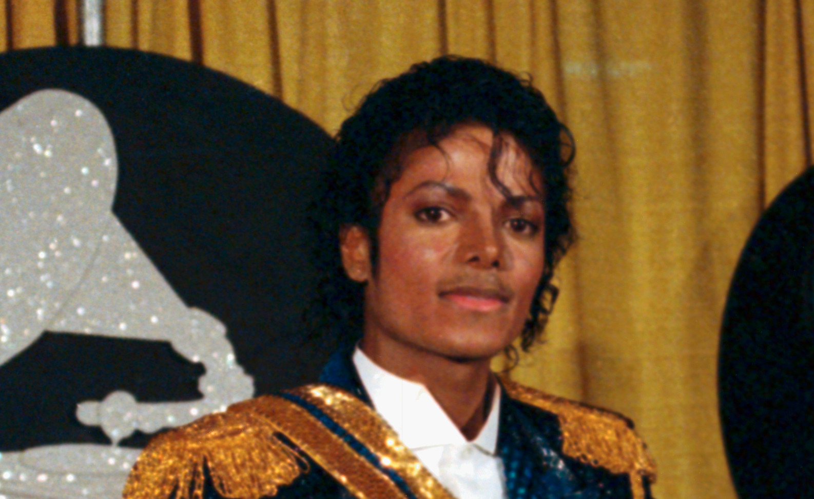 Singer Michael Jackson is shown with two armfuls of award statues at the 1984 Grammy Awards.