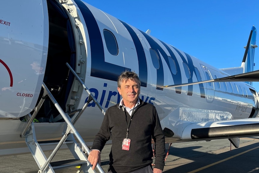 Man standing on the stairs of an aircraft