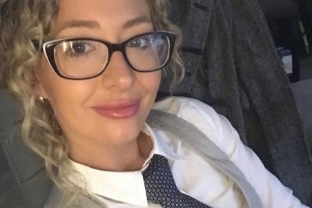 Karly Rae selfie with grey vest and blue checker-ed tie