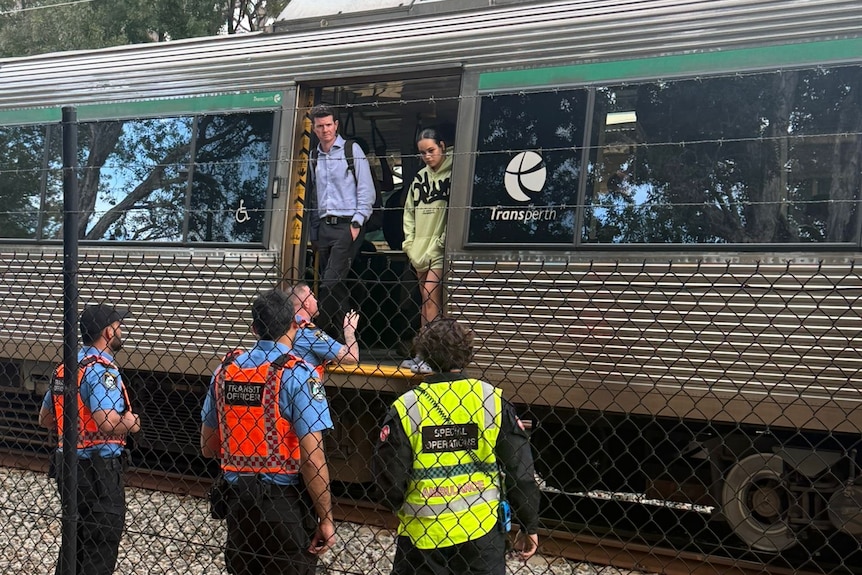 People stand on a stationary train