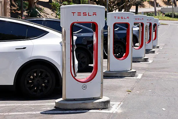 Tesla vehicles being charged.
