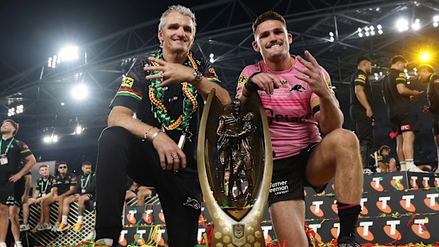 Nathan Cleary (R) of the Panthers poses with the Provan-Summons Trophy alongside his father and coach Ivan Cleary