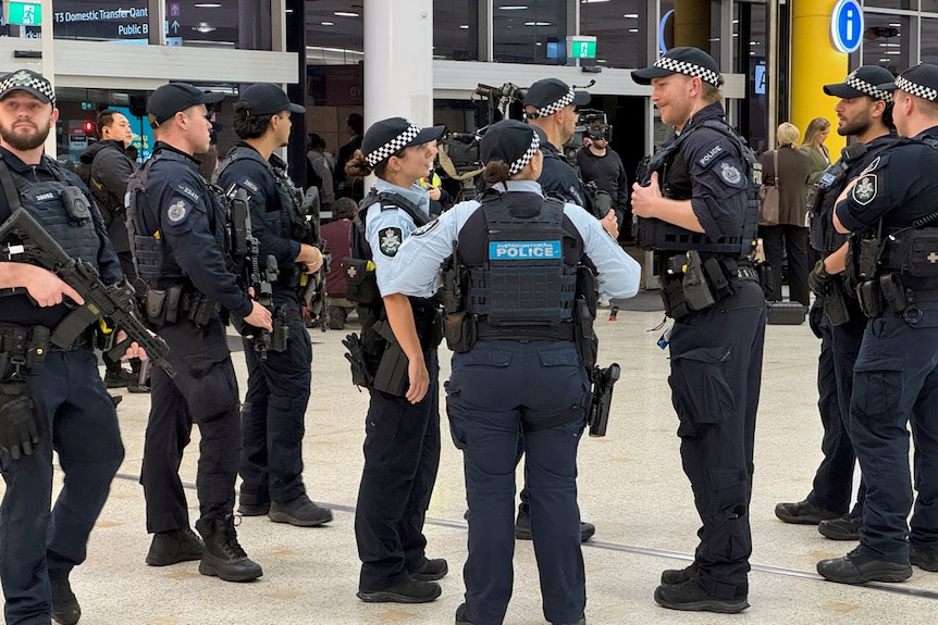 A group of long armed AFP officers at Sydney Airport.