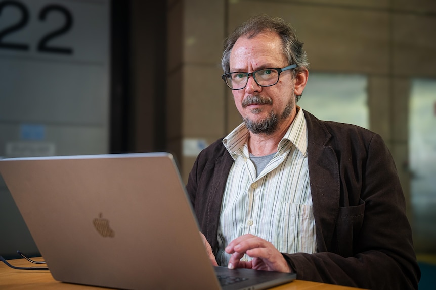 Jason Ward on his laptop